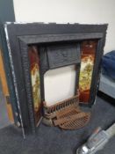 A 19th century cast iron tiled insert together with an associated fire grate