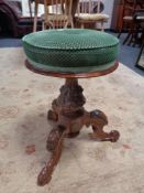 A Victorian carved mahogany revolving stool on tripod base