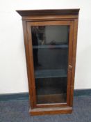 A glazed single door wall cabinet