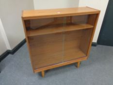 A set of twentieth century teak sliding glass door shelves