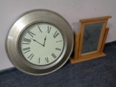 An oversized battery operated wall clock together with a contemporary oak dressing table mirror