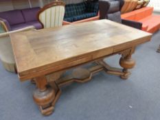 An early 20th century oak pull out dining table on heavy bulbous legs CONDITION REPORT: