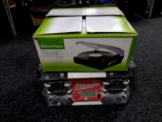 A Milwaukee radio together with a stand alone record player in box