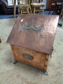 A copper and brass Art Nouveau coal receiver with lion mask handles
