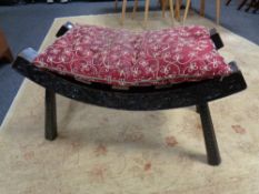 A 19th century carved ebonised stool