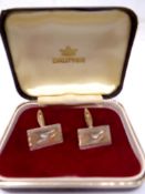 A pair of silver cufflinks