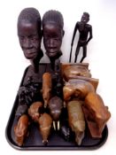 A tray of carved hardwood tourist pieces, book end, ornaments,