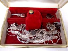 A jewellery box containing silver jewellery including bracelets, coin bracelet, rings,