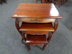 A nest of three Eastern hardwood tables on cabriole legs