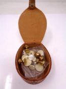 A leather box containing collar studs