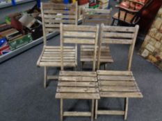 Four folding teak garden chairs