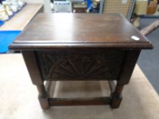 A carved oak sewing box