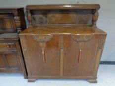 A 1930's carved oak sideboard