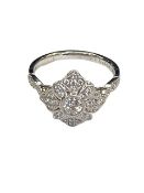 A platinum diamond cluster ring, approximately 0.57ct, size M.