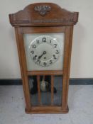 An oak eight day wall clock with silvered dial