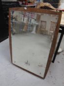 An unframed mirror mounted on board