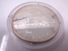 A silver fifty dollar coin depicting a Steam engine