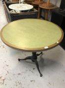 A circular oak inset paneled bar table on a cast iron pedestal base
