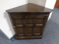 An oak low corner cabinet