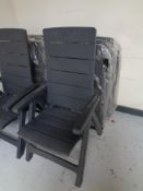 A set of four folding plastic garden armchairs