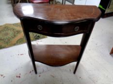 A reproduction mahogany shaped hall table