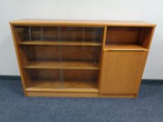 A teak sliding glass door bookcase