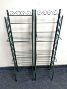 A pair of folding metal green house plant stands and a print of a sailing boat