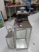 Two contemporary metal candle holders