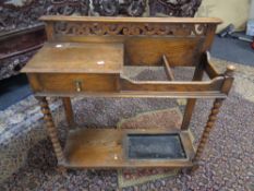 An Edwardian oak hall stand on bobbin legs