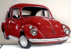 A battery operated enamelled sign in the form of a car