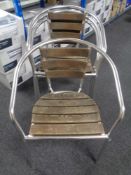 A set of four wooden and tubular metal stacking armchairs