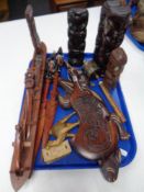 A tray of African and Tiki tourist carvings