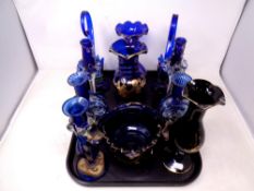 A tray of blue and gilt glass ware including candlesticks,