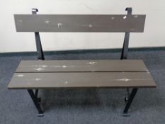 A wrought iron and wood garden bench