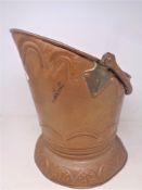 A copper swing handled coal bucket