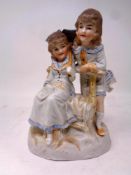 A Bisque figure of two girls