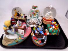 Three Disney snow globes and three further Disney ornaments