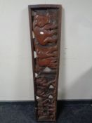 A 20th century African carved hardwood panel