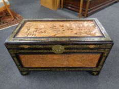 A caved camphor wood blanket chest