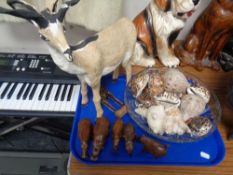 A tray of model of an antelope, hardwood animal carvings, sea shells,