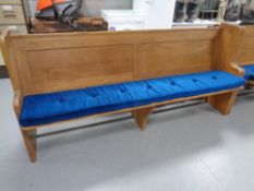 An oak church pew, with cushion,
