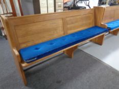 An oak church pew, with cushion,