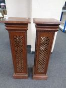 A pair of fretwork torcheres