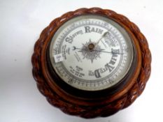 A carved oak barometer