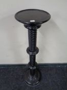 An ebonised barley twist torchere