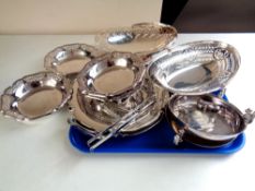 A tray of stainless steel serving plates and swing handled baskets etc