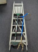 A set of folding wooden garden steps together with two garden tools