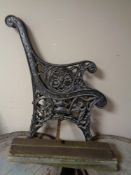 A cast iron wooden slatted garden seat