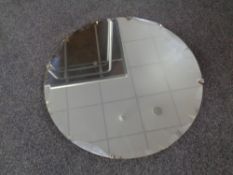 A twentieth century circular frameless beveled-edge mirror.