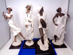 Four Giuseppe Armani Art Deco style figures.